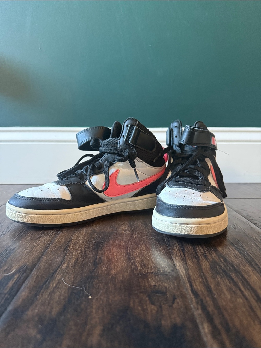 Nike Kids Black and White High-Top Sneakers with Pink Swoosh
